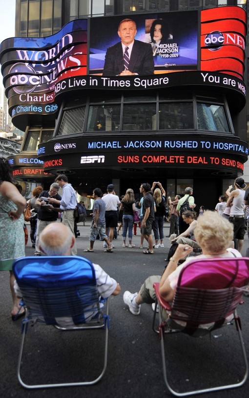Total shock: Fans in Times Square, New York, watch the news break of Michael Jackson's fatal heart attack