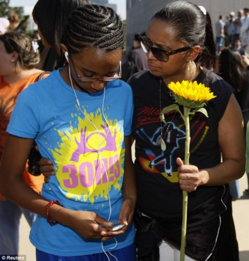Support: A mother, Yoshika Plair (right) hugs her daughter Summer outside UCLA as they take in the news of Michael Jackson's death