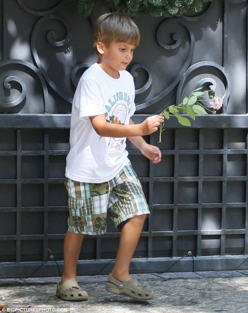 Floral tribute: A young fan lays a flower in memory of Michael Jackson outside the singer's former childhood home